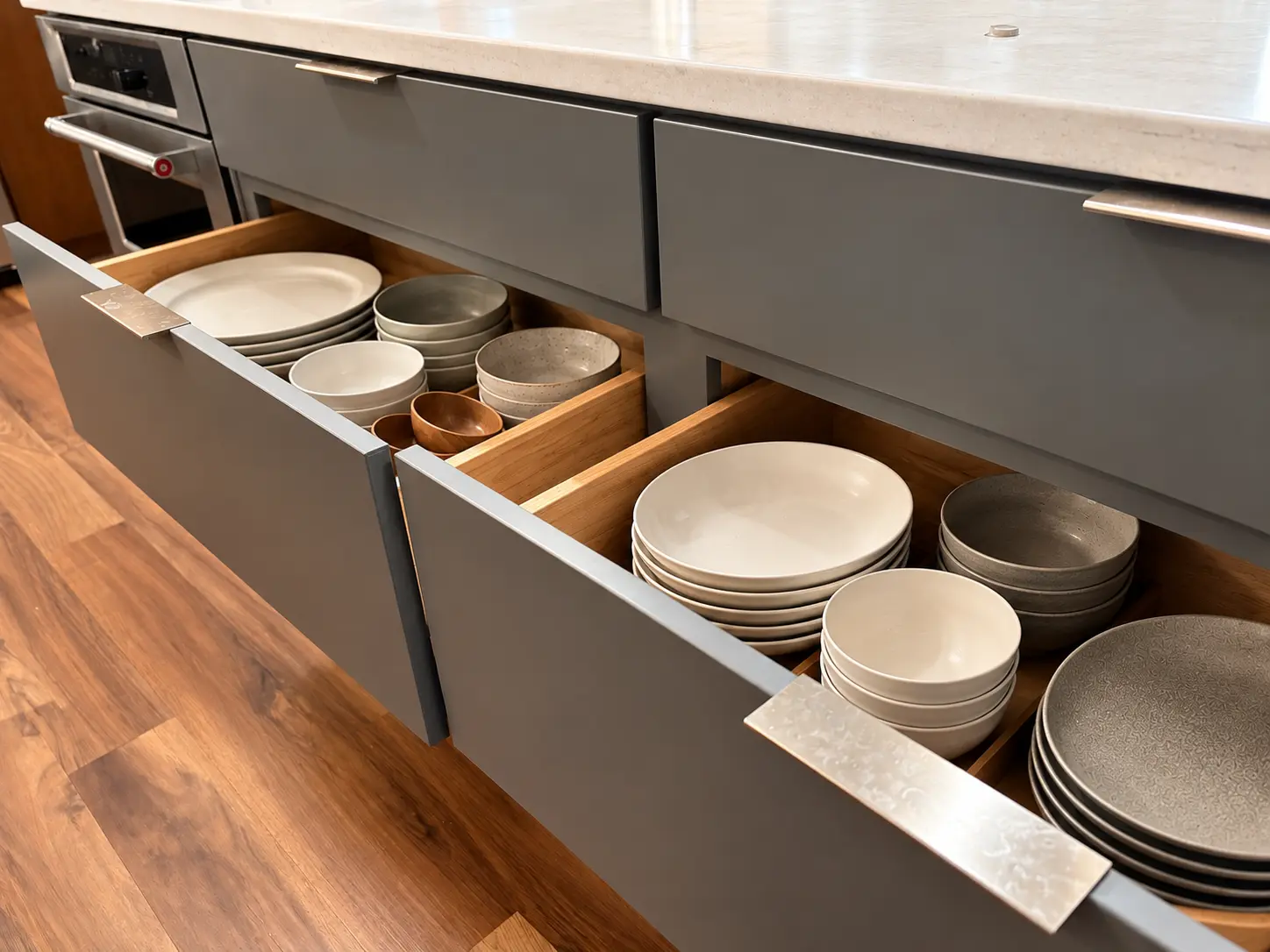 Deep pull-out kitchen drawers organized with everyday plates and bowls